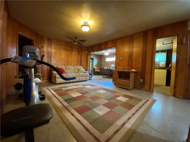 workout area with wooden walls and ceiling fan