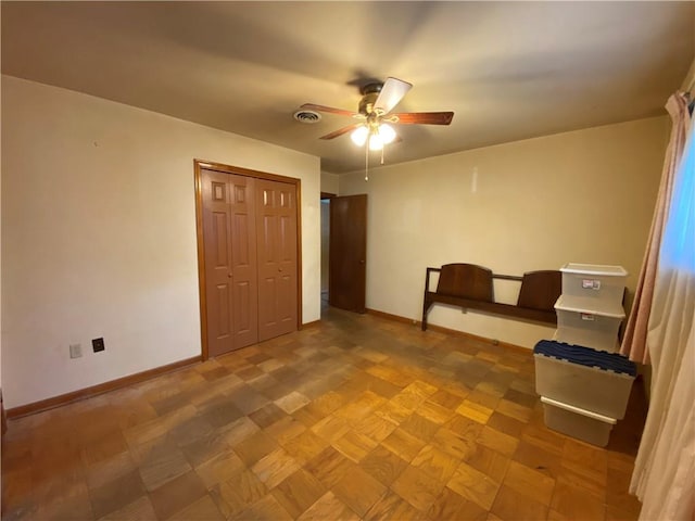 unfurnished bedroom with ceiling fan, a closet, visible vents, and baseboards