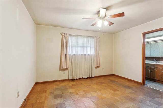 1017 Elmeer Ave, Metairie, LA 70005 - unfurnished room with plenty of natural light, baseboards, ceiling fan, and a sink
