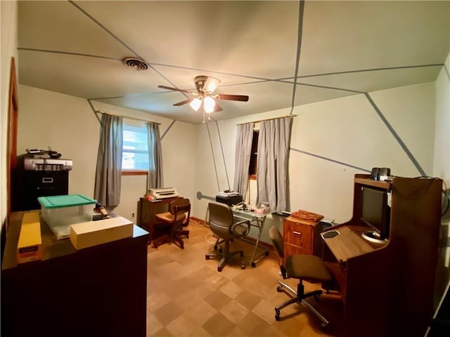 office space with tile patterned floors, visible vents, and a ceiling fan