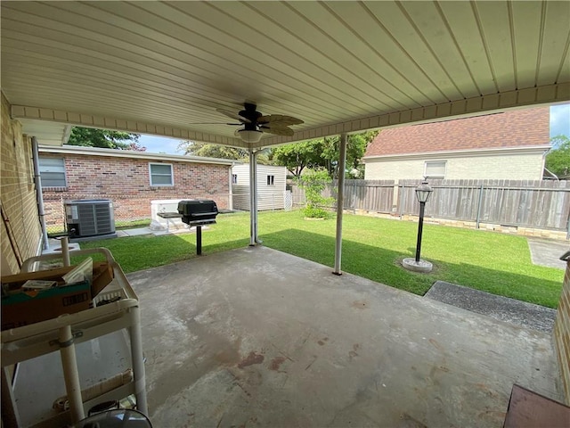 view of patio / terrace with an outdoor structure, central AC unit, ceiling fan, and a fenced backyard