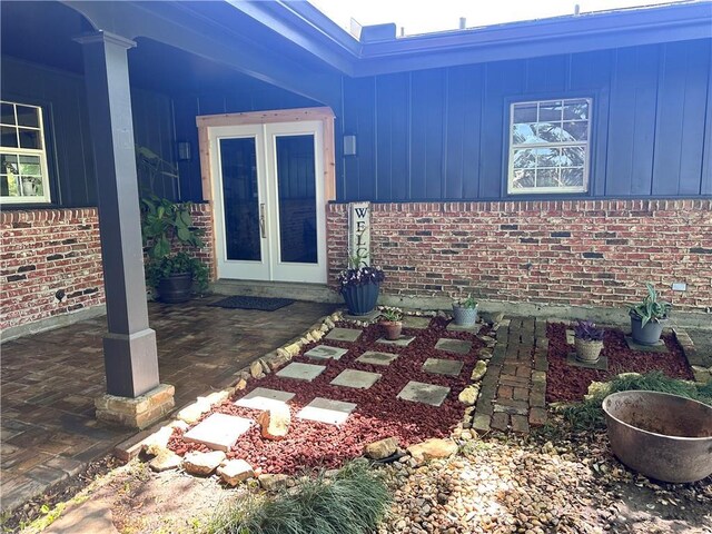 130 N Oak Ct, Luling, LA 70070 - entrance to property featuring brick siding, board and batten siding, and french doors