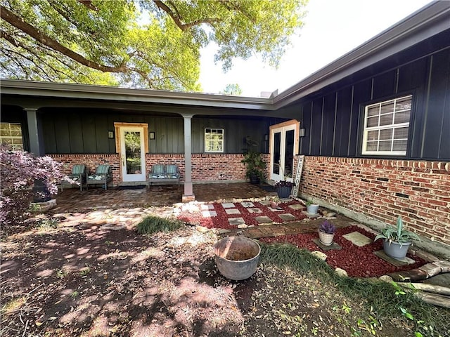 130 N Oak Ct, Luling, LA 70070 - view of exterior entry with brick siding and board and batten siding