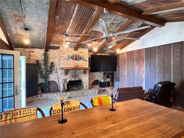 130 N Oak Ct, Luling, LA 70070 - dining room featuring wooden walls, a brick fireplace, and a ceiling fan