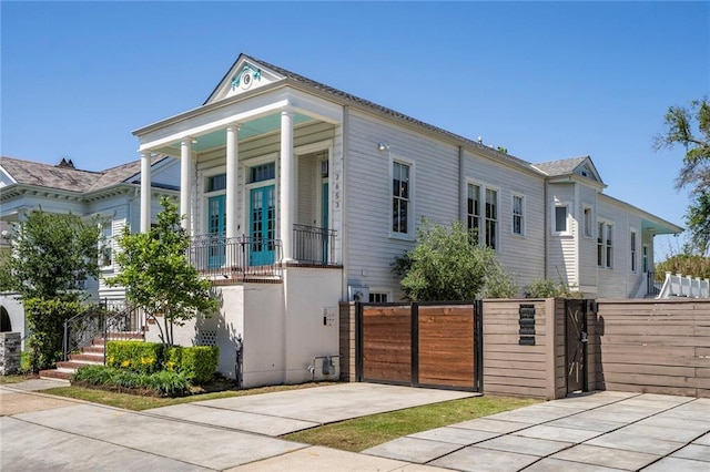view of front of house featuring a fenced front yard and a gate