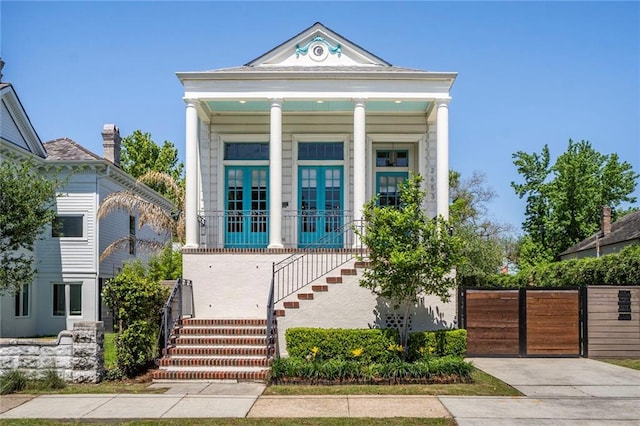 view of front of house featuring a porch, a gate, and stairway