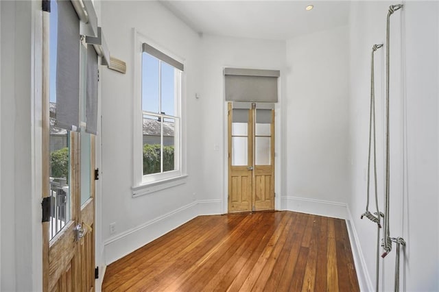 foyer featuring baseboards and hardwood / wood-style floors