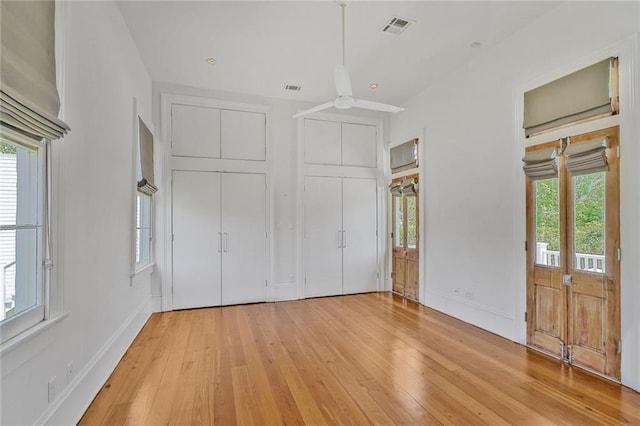 unfurnished bedroom featuring light wood-style floors, baseboards, and visible vents