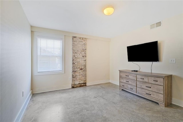 bedroom with concrete floors, visible vents, and baseboards