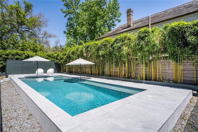 view of swimming pool with a fenced backyard and a fenced in pool