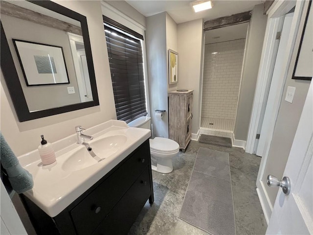 full bath with toilet, a stall shower, vanity, and baseboards