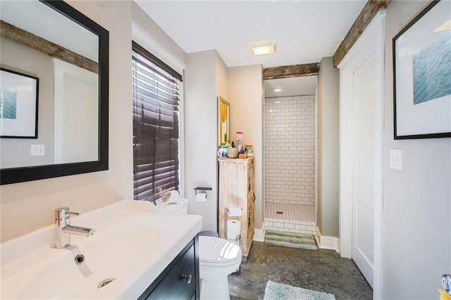 full bath with toilet, vanity, and a stall shower
