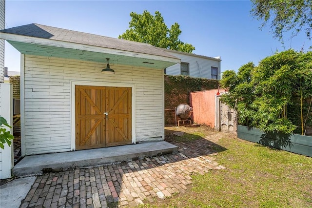 view of shed featuring fence