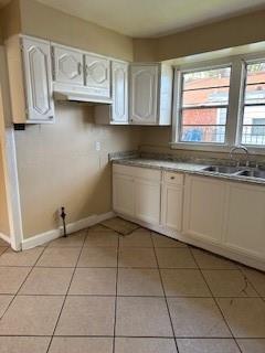 2829 Boyd St, New Orleans, LA 70131 - kitchen featuring light tile patterned floors, a sink, and a healthy amount of sunlight