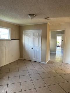 2829 Boyd St, New Orleans, LA 70131 - unfurnished bedroom featuring a closet, light tile patterned floors, and a textured ceiling