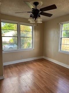 2829 Boyd St, New Orleans, LA 70131 - empty room featuring a textured ceiling, wood finished floors, and baseboards