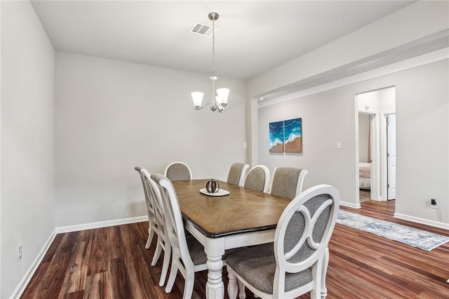 316 Providence Bay Rd, Slidell, LA 70461 - dining area with baseboards, wood finished floors, a notable chandelier, and visible vents