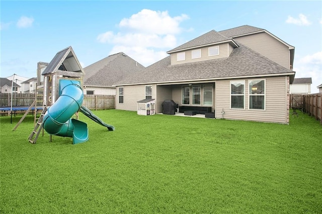 316 Providence Bay Rd, Slidell, LA 70461 - back of house with a trampoline, a yard, and a fenced backyard