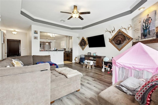 2925 Monica Ln, Marrero, LA 70072 - living area featuring ornamental molding, a ceiling fan, visible vents, a raised ceiling, and wood finished floors