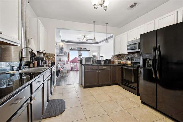 2925 Monica Ln, Marrero, LA 70072 - kitchen featuring visible vents, light tile patterned floors, a sink, a tray ceiling, and black appliances