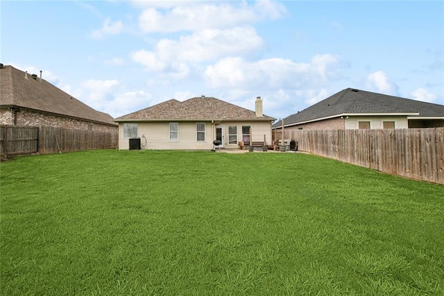 2925 Monica Ln, Marrero, LA 70072 - rear view of house featuring central AC unit, a yard, a patio area, a chimney, and a fenced backyard
