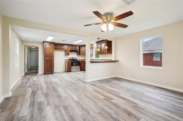 unfurnished living room with light wood finished floors, visible vents, baseboards, and a ceiling fan