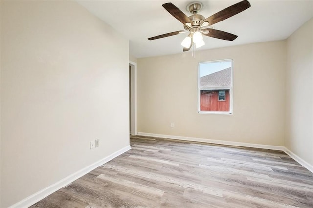 empty room featuring baseboards, ceiling fan, and wood finished floors