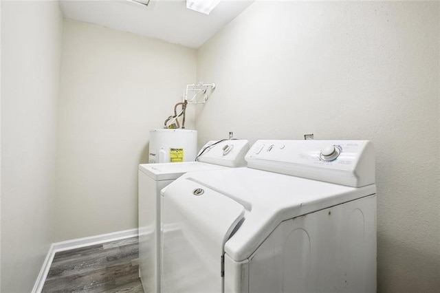 washroom with baseboards, laundry area, independent washer and dryer, wood finished floors, and water heater