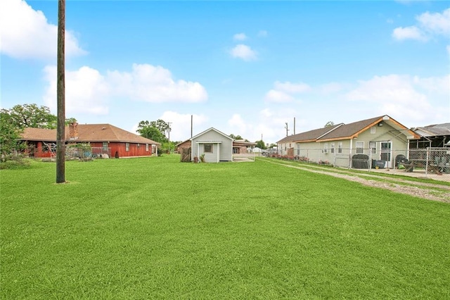view of yard with an outdoor structure and fence