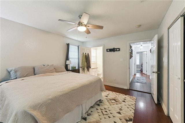 5387 Chamberlain Dr, New Orleans, LA 70122 - bedroom with dark wood-style flooring, baseboards, ensuite bathroom, and ceiling fan