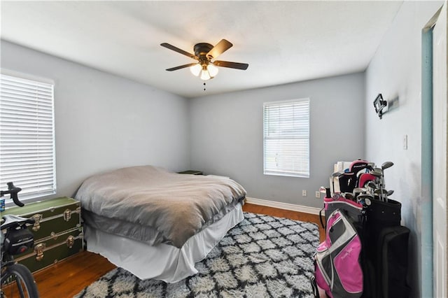 5387 Chamberlain Dr, New Orleans, LA 70122 - bedroom with wood finished floors, ceiling fan, and baseboards