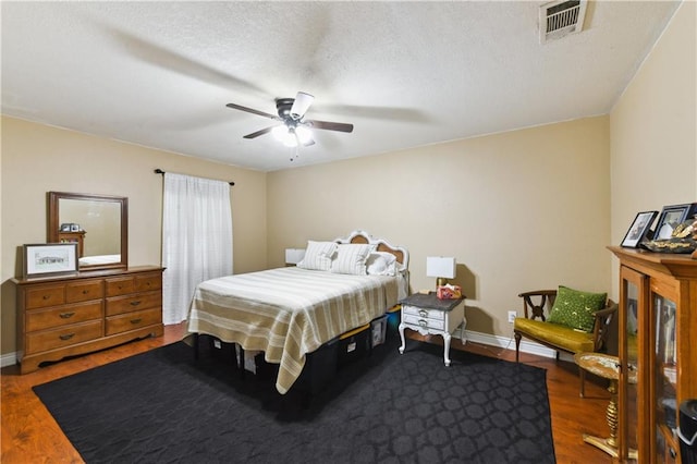 5387 Chamberlain Dr, New Orleans, LA 70122 - bedroom featuring visible vents, baseboards, a ceiling fan, a textured ceiling, and wood finished floors