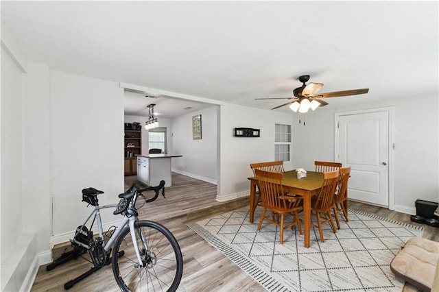 5387 Chamberlain Dr, New Orleans, LA 70122 - dining area featuring light wood-style floors, ceiling fan, and baseboards