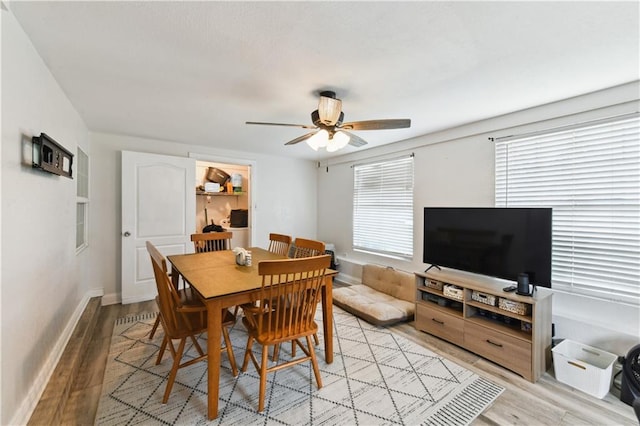 5387 Chamberlain Dr, New Orleans, LA 70122 - dining space with light wood-style flooring, ceiling fan, and baseboards