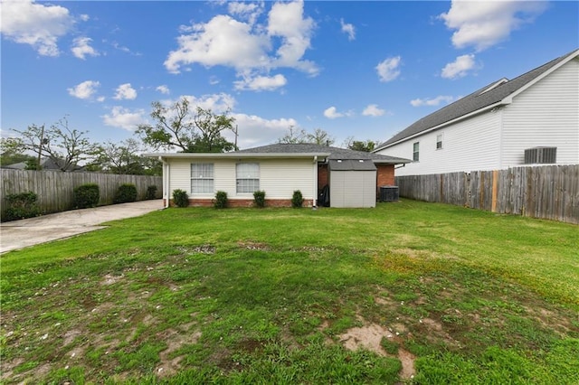 5387 Chamberlain Dr, New Orleans, LA 70122 - rear view of property featuring a yard, fence private yard, and brick siding