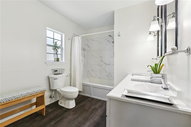 bathroom featuring vanity, baseboards, toilet, shower / bath combo with shower curtain, and wood finished floors