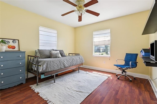 bedroom featuring ceiling fan, baseboards, and wood finished floors