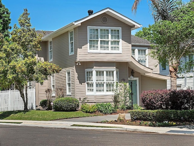 view of front of home featuring fence