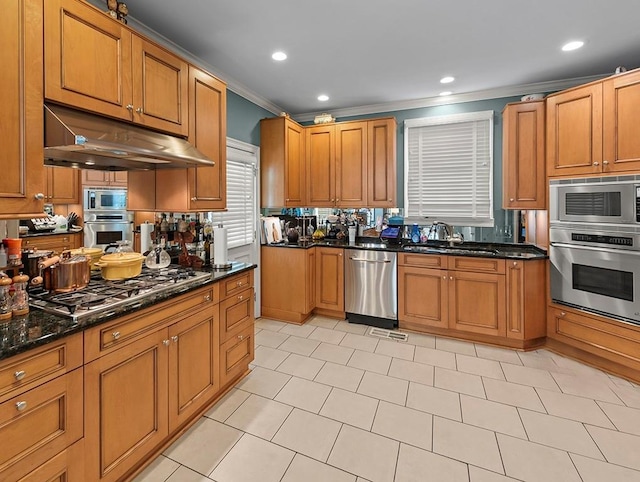 kitchen featuring crown molding, under cabinet range hood, brown cabinetry, appliances with stainless steel finishes, and a sink