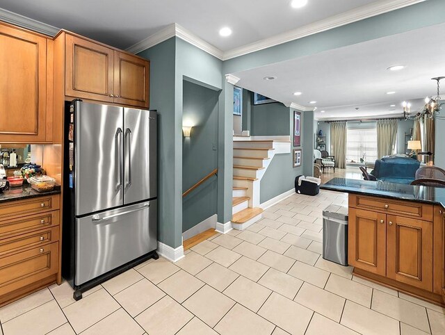kitchen with baseboards, stainless steel fridge, recessed lighting, crown molding, and brown cabinetry