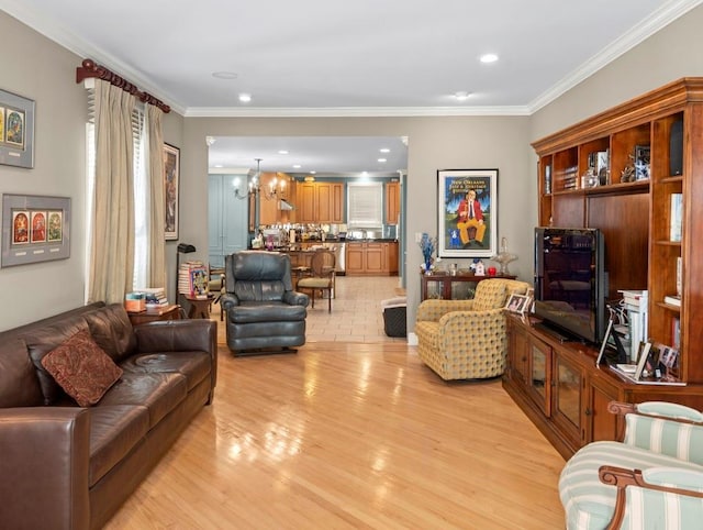 living area featuring crown molding, light wood finished floors, a notable chandelier, and recessed lighting