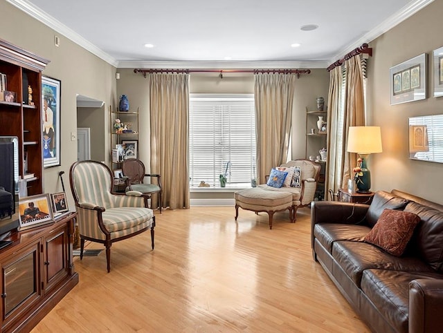 living room featuring light wood-type flooring, ornamental molding, and recessed lighting