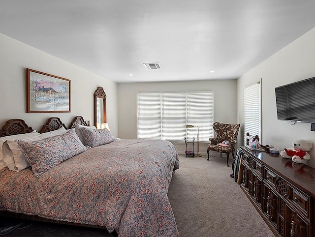 carpeted bedroom with recessed lighting, visible vents, multiple windows, and baseboards