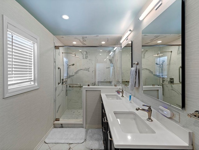 full bath featuring recessed lighting, a sink, and a marble finish shower