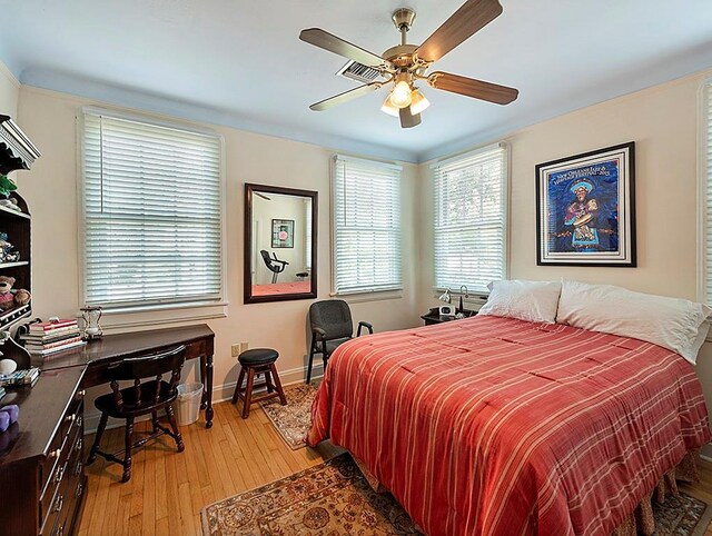 1643 S Norman Francis Pkwy, New Orleans, LA 70125 - bedroom with light wood-type flooring, baseboards, ceiling fan, and a desk
