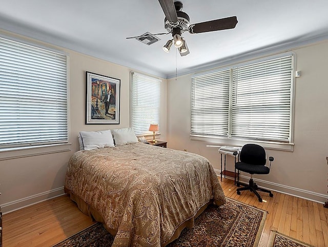 bedroom featuring light wood-style floors, ceiling fan, and baseboards