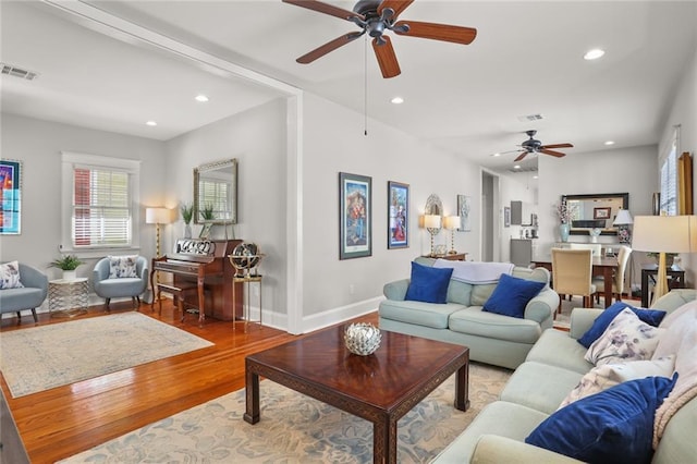 living area with ceiling fan, visible vents, recessed lighting, wood finished floors, and baseboards