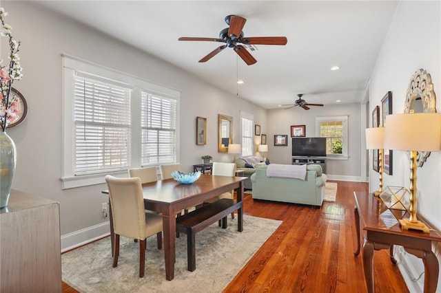 dining room with baseboards, a ceiling fan, hardwood / wood-style floors, and recessed lighting