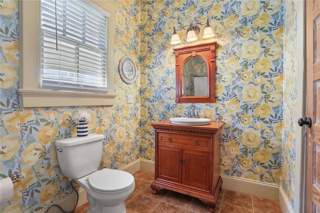bathroom with tile patterned flooring, baseboards, wallpapered walls, and toilet