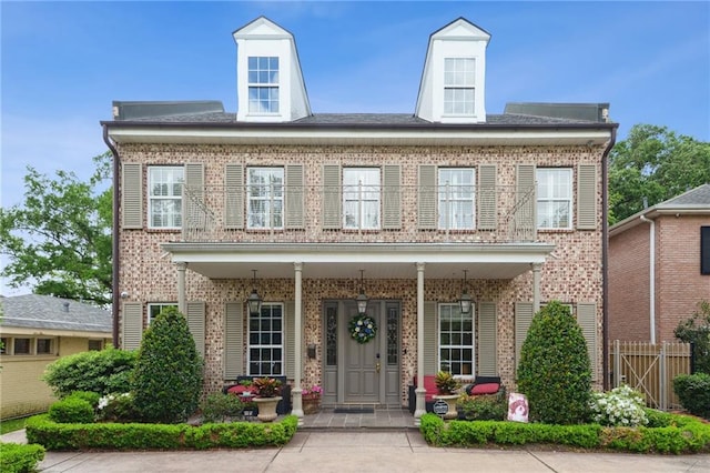 59 Spanish Fort Blvd, New Orleans, LA 70124 - georgian-style home with brick siding, fence, and covered porch